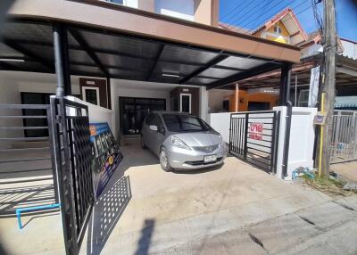 Spacious driveway with carport in front of residential home