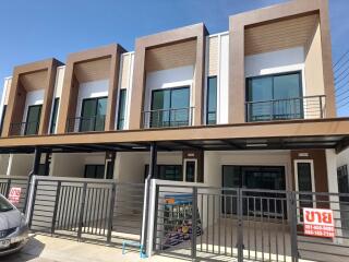 Modern residential townhouses with balconies and carports