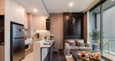 Modern open plan living room with adjacent kitchen, showcasing stylish furniture and decor