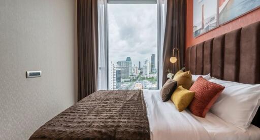 Cozy bedroom with city view through large window