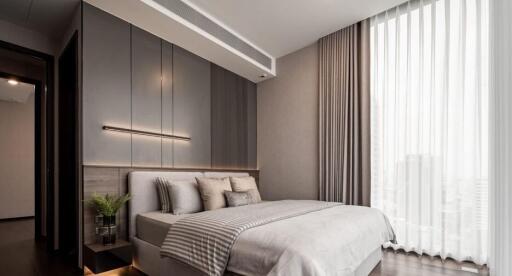 Modern bedroom with stylish interior design, featuring a large bed, sleek lighting, and elegant decor