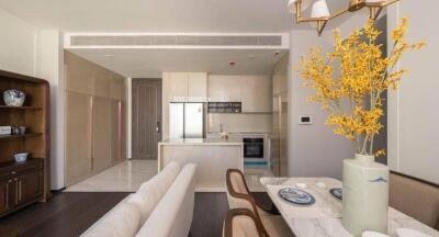 Modern kitchen with integrated living space featuring elegant furnishing and autumnal decor