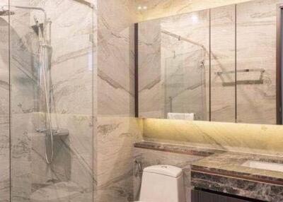 Elegant bathroom with marble finishes and glass shower