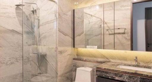 Elegant bathroom with marble finishes and glass shower