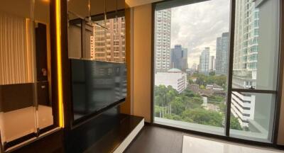 Modern bedroom with panoramic city view through large windows