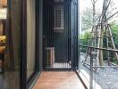 Modern balcony with glass and metal details overlooking a garden