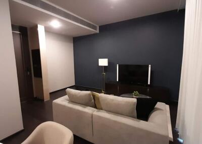 Modern living room with sophisticated dark blue walls and plush seating