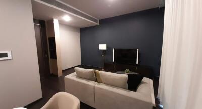 Modern living room with sophisticated dark blue walls and plush seating