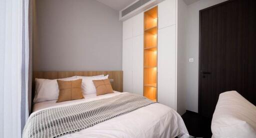 Modern bedroom with double bed and stylish lighting