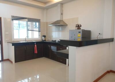Spacious modern kitchen with large window and ample counter space