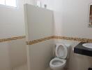 Clean white bathroom with mosaic tile detailing