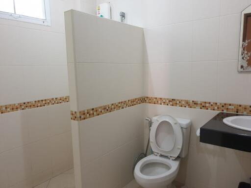 Clean white bathroom with mosaic tile detailing