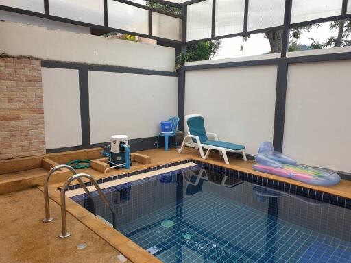 Indoor swimming pool with lounging chairs and play items