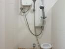 Modern tiled bathroom with electric shower and handheld shower head