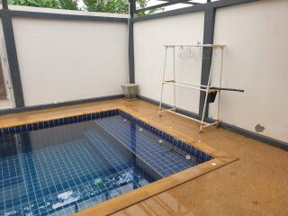 Outdoor swimming pool with adjacent drying area