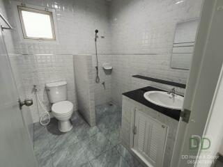 Modern bathroom with white wall tiles and gray floor tiles
