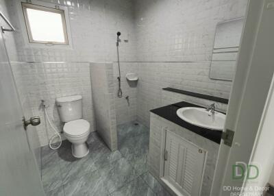 Modern bathroom with white wall tiles and gray floor tiles