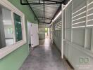 Spacious covered patio with green walls and tiled flooring