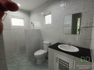 Modern bright bathroom with tiled walls and flooring