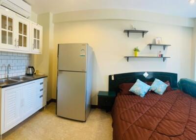 Compact studio apartment with integrated kitchen and sleeping area