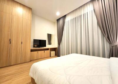 Modern bedroom with wooden wardrobe and large bed