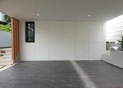 Modern living room with large tiled floor and white panel walls