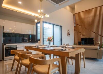 Modern kitchen with dining area featuring wooden furniture and stylish interior design
