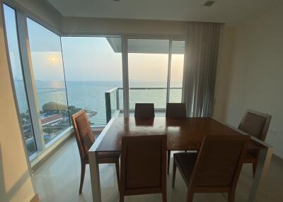 Bright dining room with ocean view and large windows