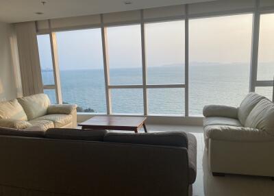 Spacious living room with large windows overlooking the sea
