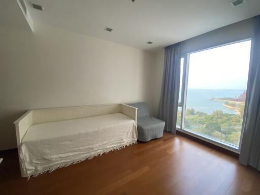 Spacious living room with large window overlooking the sea