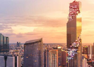 Modern skyscrapers in city at sunset with dramatic sky