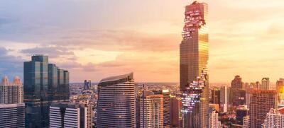 Modern skyscrapers in city at sunset with dramatic sky