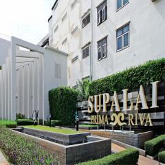 Modern residential building entrance with manicured green lawn and elegant signage