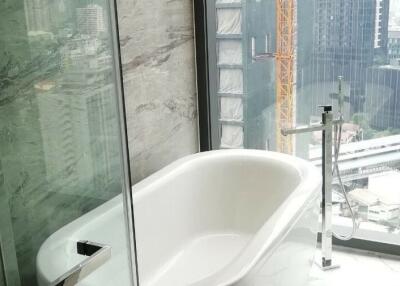 Modern bathroom with city view through large window