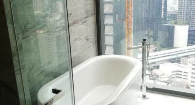 Modern bathroom with city view through large window