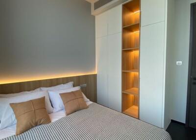 Modern bedroom with ambient lighting and built-in shelving