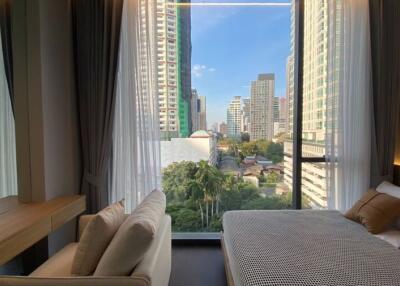 Cozy bedroom with cityscape view through large windows