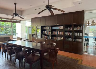 Spacious living room with library and dining area