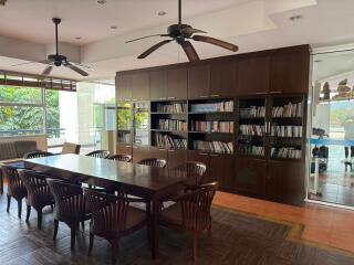 Spacious living room with library and dining area