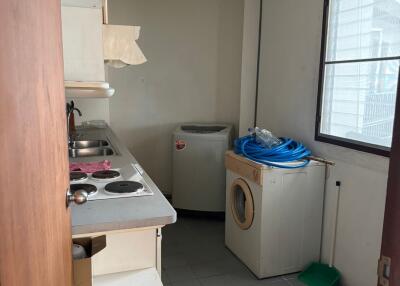 Compact kitchen space with storage and laundry facilities