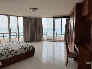 Spacious bedroom with ocean view and balcony access