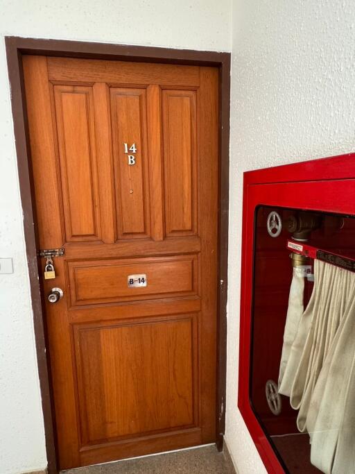 Wooden apartment door with number 14B