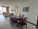 Spacious living room with dining area and access to sunlit balcony