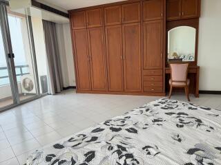 Spacious bedroom with large wardrobe and balcony access