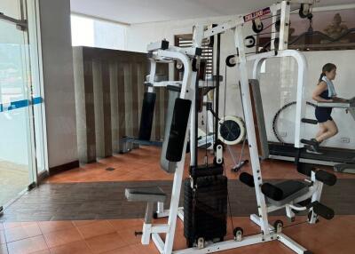 Spacious home gym with modern equipment and pool view
