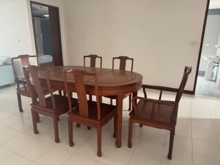 Spacious dining room with large wooden table and chairs