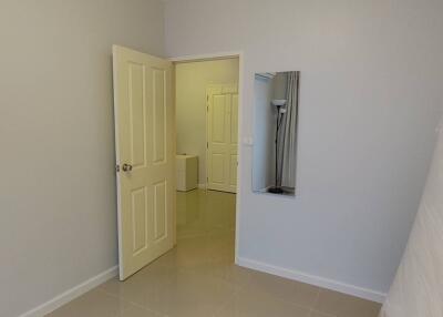 Unfurnished bedroom with open door leading to a hallway