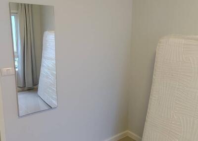 Minimalist bedroom with tiled floor and wall-mounted mirror