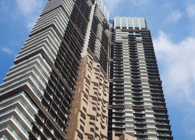 Modern high-rise residential building against a clear blue sky