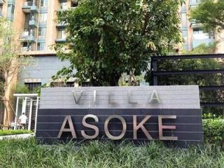 Front signage of Villa Asoke with green landscaping